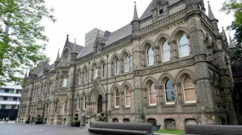 A large grand looking rectangular building which is the home of MIddlesbrough Council. It has dozens of windows and a number of turrets  