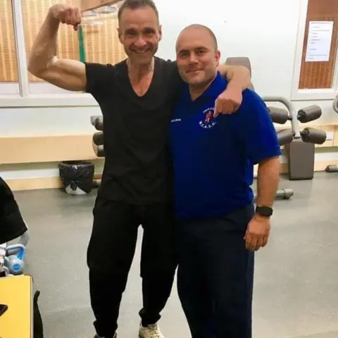 Jon Madden Jon Madden flexing his bicep during Chris Scordis's physiotherapy programme