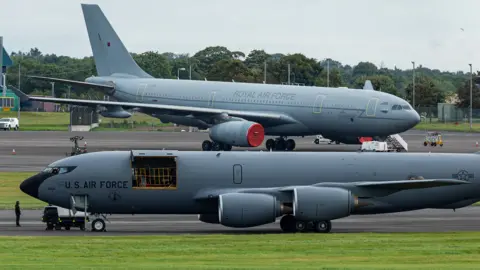 Cmc images Two grey coloured military planes on a runway