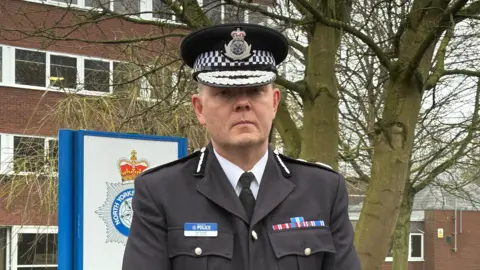 Chief Con Tim Forber in black uniform standing outside Fulford Road Police Station in York