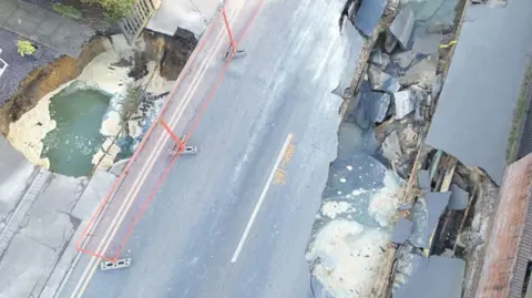 SURREY FIRE AND RESCUE SERVICE An aerial image of the two sinkholes in Godstone village.