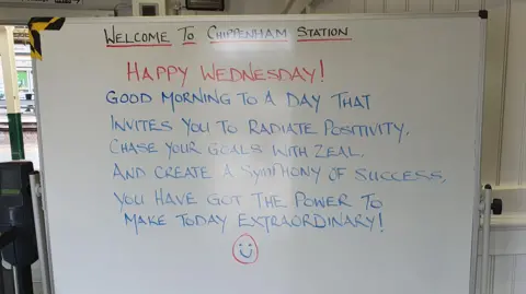 BBC A whiteboard message board that says Welcome to Chippenham Station, along with a positive quote for Wednesday