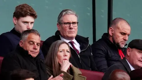 PA Media Prime Minister Sir Keir Starmer attends a football game. 