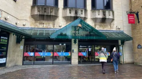 Shoppers walking into Grosvenor shopping centre in Northampton