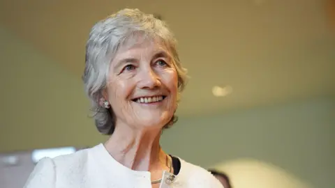 Irish president Catherine Connolly during a visit to Leeds University, as part of her official visit to the UK. She has short white hair and wearing a cream cardigan.