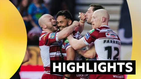 Wigan players celebrate a try against Leigh