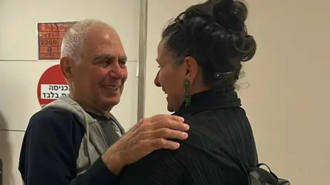 Gadi Moses embraces his niece in an Israeli hospital