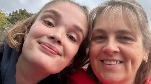 Jo Cole Ellis Humphreys poses next to her mother