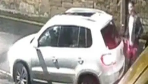 British Transport Police A grainy CCTV image showing a car and man.