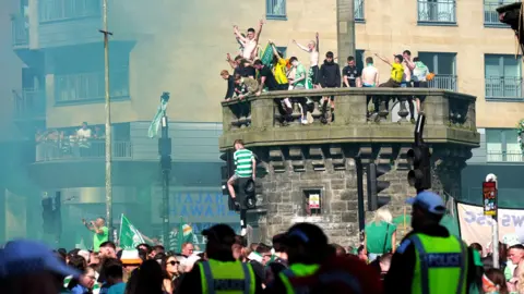PA Media Celtic supporters gathered on the top of the city's historic Mercat Cross last year