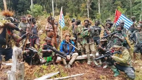 Reuters Pilot Phillip Mehrtens surrounded by rebels holding weapons