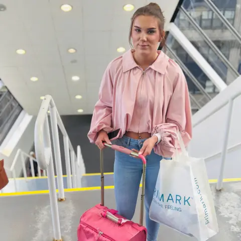 Taylor Gray, teenage girl with a pink suitcase