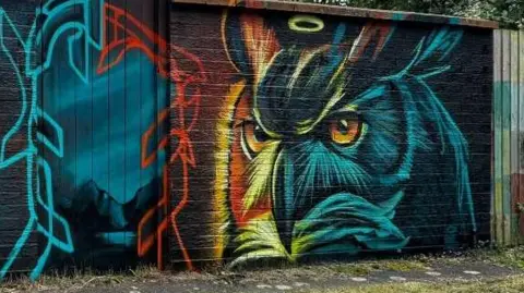 Owl artwork by Nathan Murdoch on a wall in Peterborough