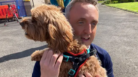 Alex Cole-Hamilton along with his dog before voting in the general election