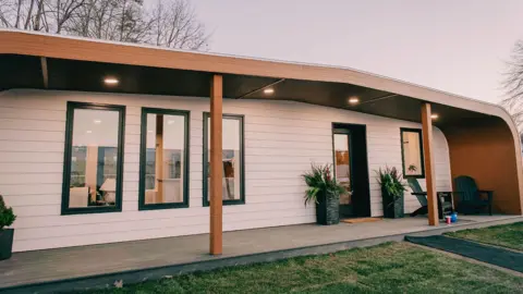 University of Maine A white bungalow with a porch at the front
