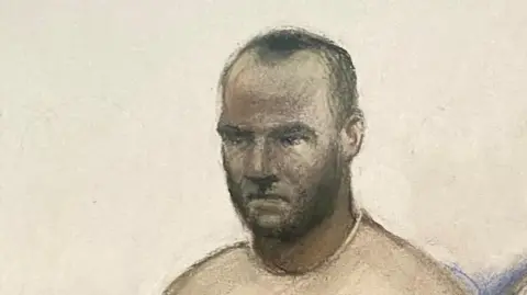 Elizabeth Cook/PA A court sketch of Hadush Kebatu, who is wearing a grey sweater and has short black hair.