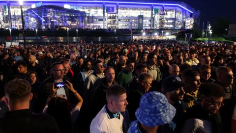 Fans queue for transport after England's opener against Serbia 