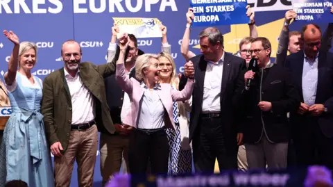 EPA European Commision President Ursula von der Leyen (3-L) and Bavarian Premier Markus Soeder (C) hold hands, at the end of the final campaign rally of CDU and CSU for the European elections in Munich Germany, 07 June 2024.