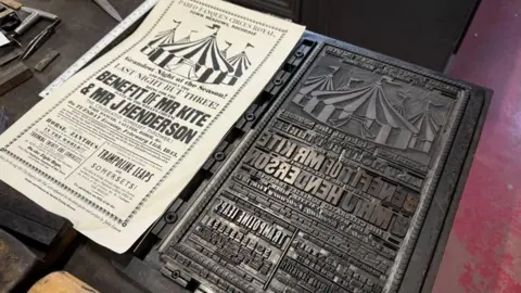 A print and its printing block, showing the correct and reverse of the same image. It shows pictures of striped bell tent marquees and advertises "The Last Night but Three; Benefit of Mr Kite and Mr J Henderson", promoting a circus show including "Trampoline leaps" among the distinguishable text.