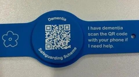 Shows the blue wristband saying dementia safeguarding scheme