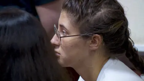 AP The side profile of Bella Culley as she sat in court. She is wearing glasses with her hair in a French plait.