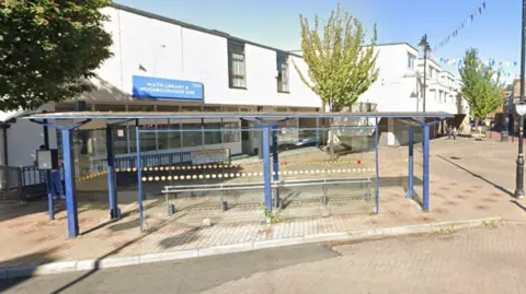 Google Images A library building and bus shelter at the top of a high street