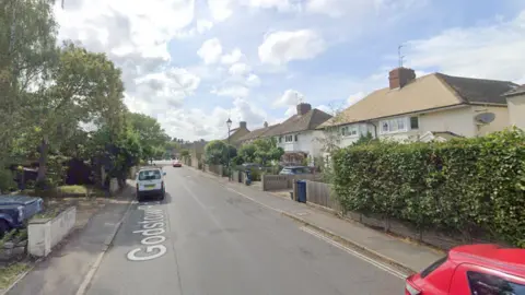 A screenshot from Google street view showing a residential street of semi-detached houses.