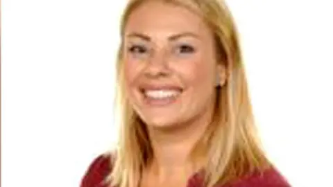 Posed headshot image of vicki williams wearing red blouse and smiling. She has long blonde hair