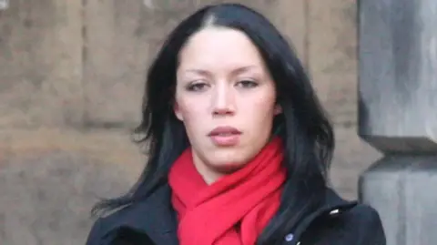 Ciaran Donnelly Denise Clair, pictured during the civil court case in 2017. She has shoulder-length black hair and is wearing a black coat and red scarf