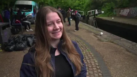 Natalia Stachowiak has brown hair and is wearing a blue jacket. She is standing on the canal towpath. 