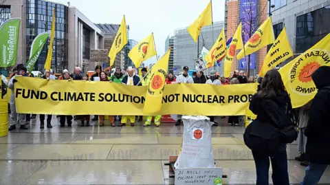 Anadolu via Getty Images Members of the anti-nuclear movement hold a demonstration marking the 15th anniversary of the Fukushima nuclear disaster as they gather in Schuman Square next to the European Commission building in Brussels, Belgium on March 11, 2026