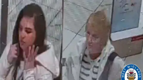 A composite image of two CCTV stills - on the left is a young woman with dark hair wearing a white coat; on the right is an older woman with short light blonde hair and glasses, wearing a white and black striped top and a white coat. A West Midlands Police logo is in the bottom right corner.