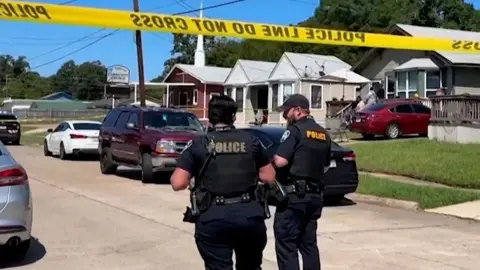 Police officers secure a street where eight children, with ages ranging from 1 to 14, were killed in a mass shooting in Shreveport, Louisiana, U.S. April 19, 2026, in a still image from video.