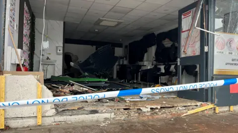 The inside of a nail bar with significant damage