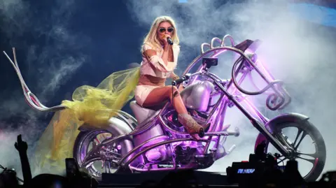 Getty Shania Twain performing on a motorcycle, the motorcycle looks like a mechinical horse