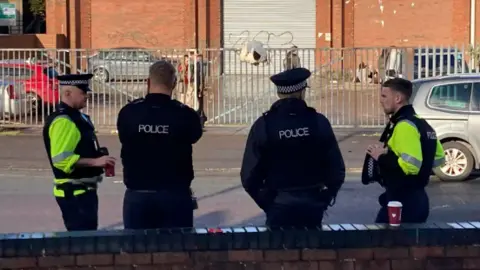 Police outside the Wickes building where the illegal rave was held