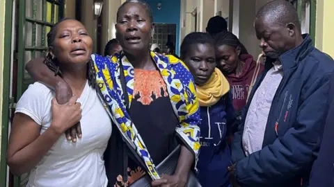 Hassan Lali / BBC Relatives crying inside a funeral parlour in Nairobi after seeing Albert Ojwang's body - Saturday 14 June 2025.