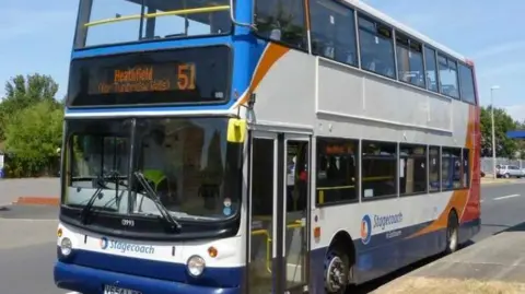 A blue and white double-decker bus travelling to Heathfield.  