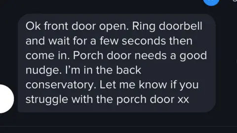 Cheshire Police A text message in white lettering against a black screen, which reads: "Ok front door open. Ring doorbell and wait for a few seconds and then come in. Porch door needs a good nudge. I'm in the back conservatory. Let me know if you struggle with the porch door xx."
