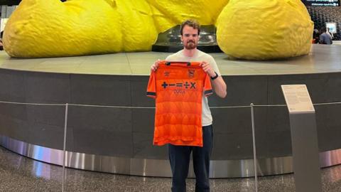 Scott Billison at Doha Airport with his Ipswich Town shirt when travelling back to the UK