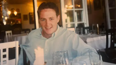 Handout An old picture of Matt Gallagher when he was younger, wearing a blue shirt sat in a restaurant