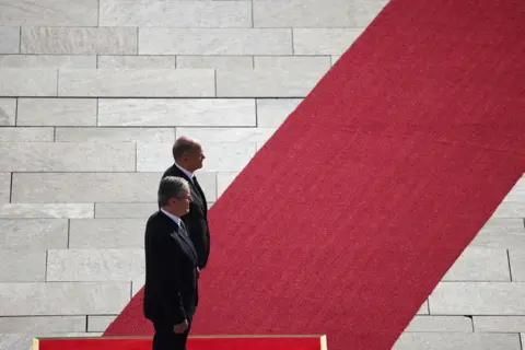 Liesa Johannssen / Reuters German Chancellor Olaf Scholz stands alongside British Prime Minister Keir Starmer