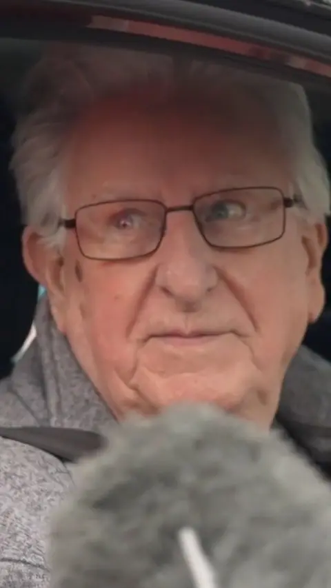 A man with grey hair and glasses