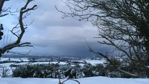 BBC Weather Watcher/Henri Bender A snowy landscape exhibiting hills and fields blanketed in snow at Newbuildings near Derry