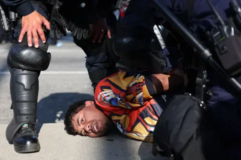 A protestor is arrested in Los Angeles on 10 June 2025