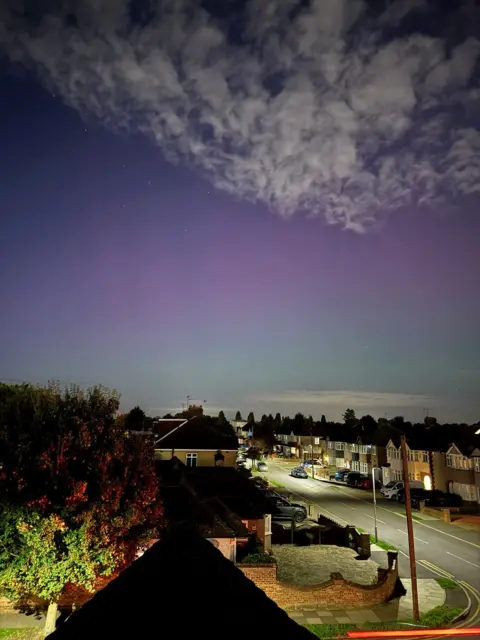 Joe/Twitter A splash of colour illuminates the night sky about a residential street in London on Thursday night