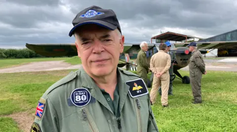 Martin Baldock in a green flightsuit