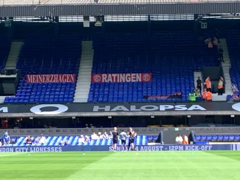 Safe standing area in the Cobbold Stand, with Fortuna Düsseldorf banners attached to it