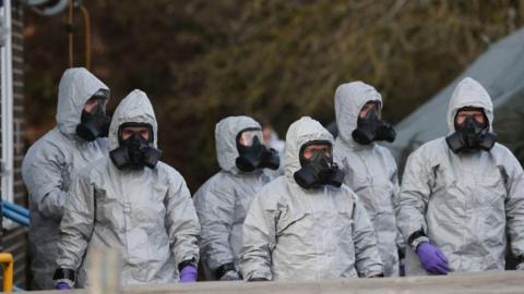 Personnel in protective coveralls and breathing equipment work at the Salisbury District Hospital in March 2018 after a man and a woman were poisoned in a nerve agent attack