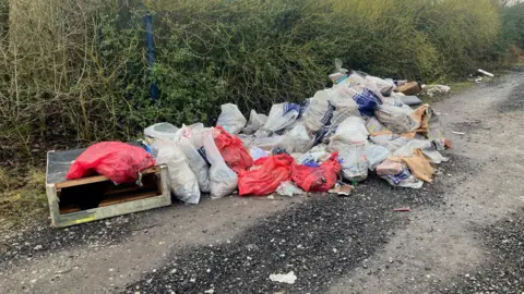 Photograph of waste dumped on Rayner Lane in Ashton-under-Lyne